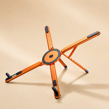 Magdesk – Orange foldable stand with five legs and black rubber tips, photographed from a higher angle on beige