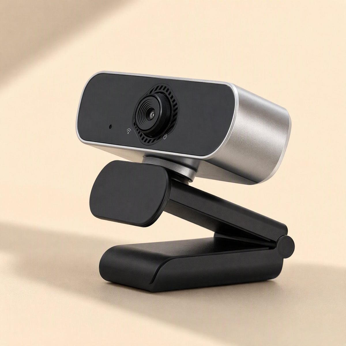 Pixelgleam – Webcam from a low side angle with the lens ring, tilting head and folding black clip stand visible