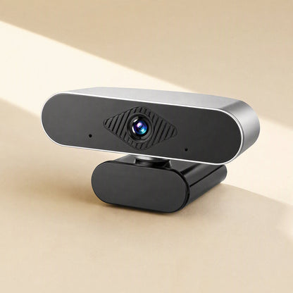 Pixelgleam – Close-up of the silver-edged webcam with diamond-textured lens panel and two small microphone holes