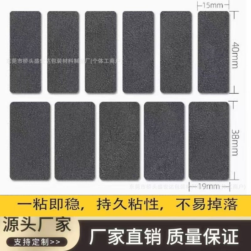 Tackmouse – Close-up of the 11 dark gray textured grip pads, six narrow 15 x 40 mm and five wide 19 x 38 mm