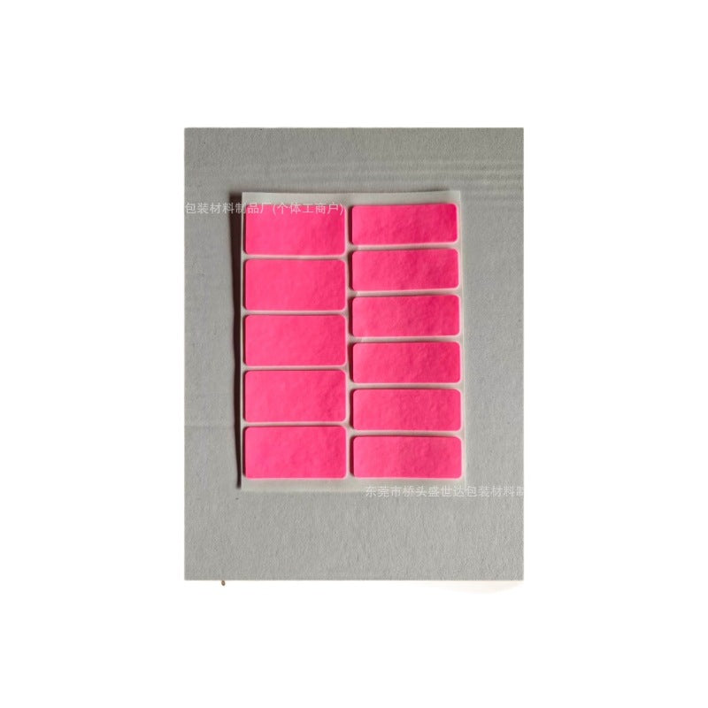 Tackmouse Mouse Anti-Slip Sticker – sheet of 11 bright pink grip pads on clear backing, laid on a gray board