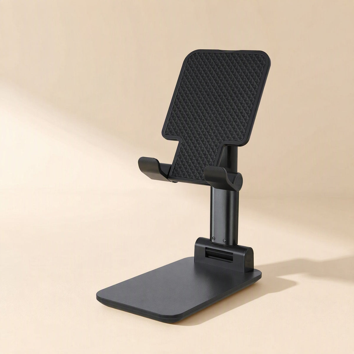 Flexperch Phone Stand – black foldable phone stand with textured backplate and two front grips, shown on a beige backdrop