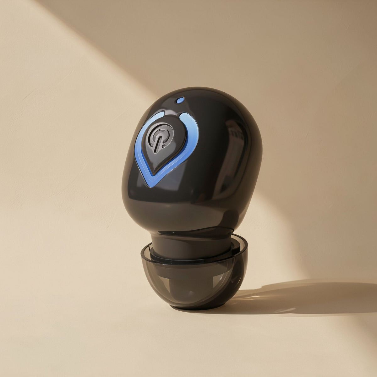 Solehear – Black earbud with blue power button ring and a translucent smoke-gray ear tip, front view in soft light