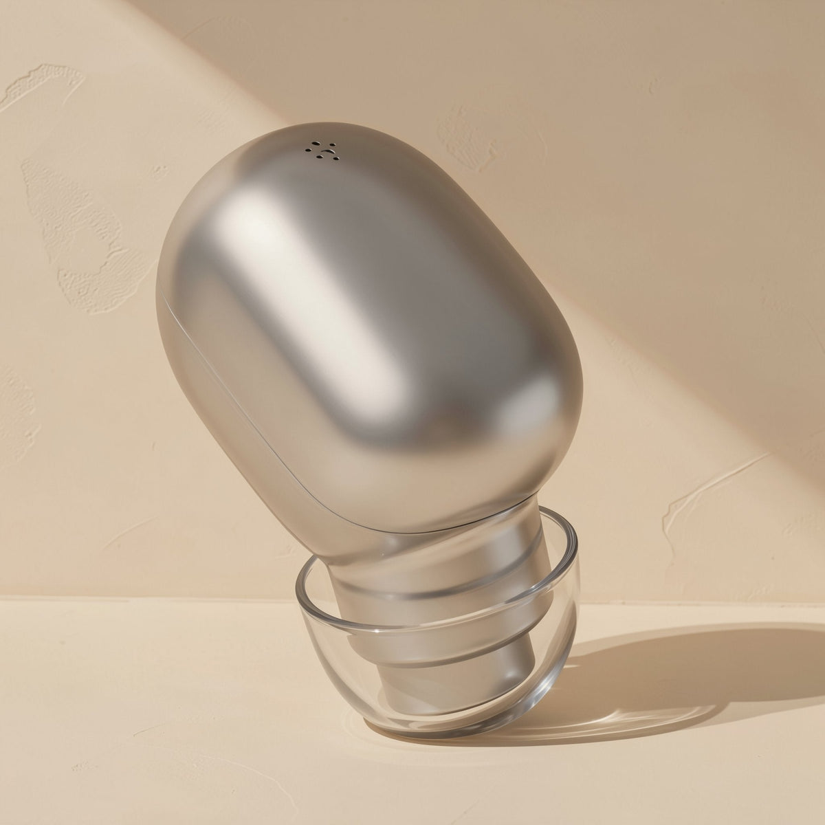 Solehear – Silver earbud with a small speaker grille at the top and a clear ear tip, angled against a cream backdrop