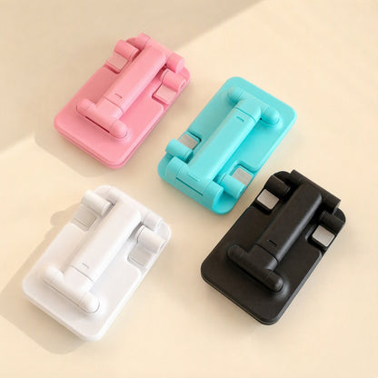 Flipangle – Pink, teal, white and black folded phone stands seen from above on a beige background