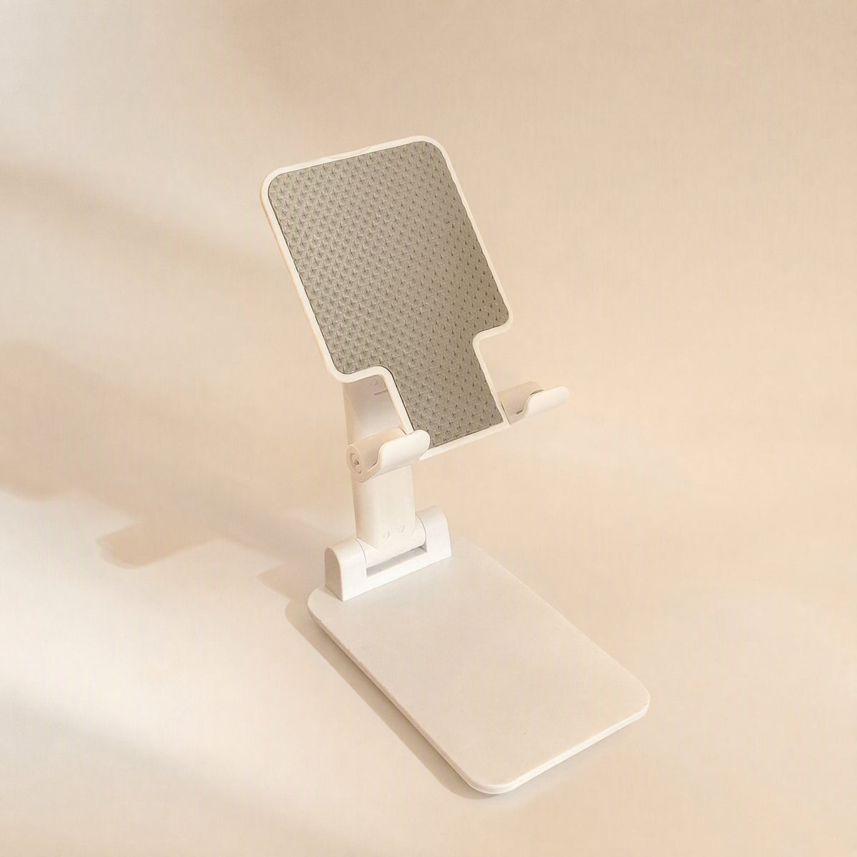Flipangle – White foldable desktop stand fully extended with raised arm and angled grey textured rest