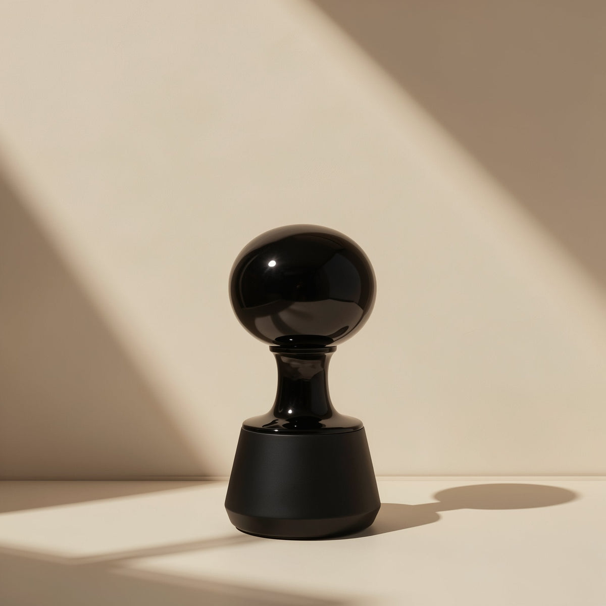 Clipbeat Clip-On Bluetooth Headphones – glossy black rounded stand with a bulbous top casting a shadow against a beige wall