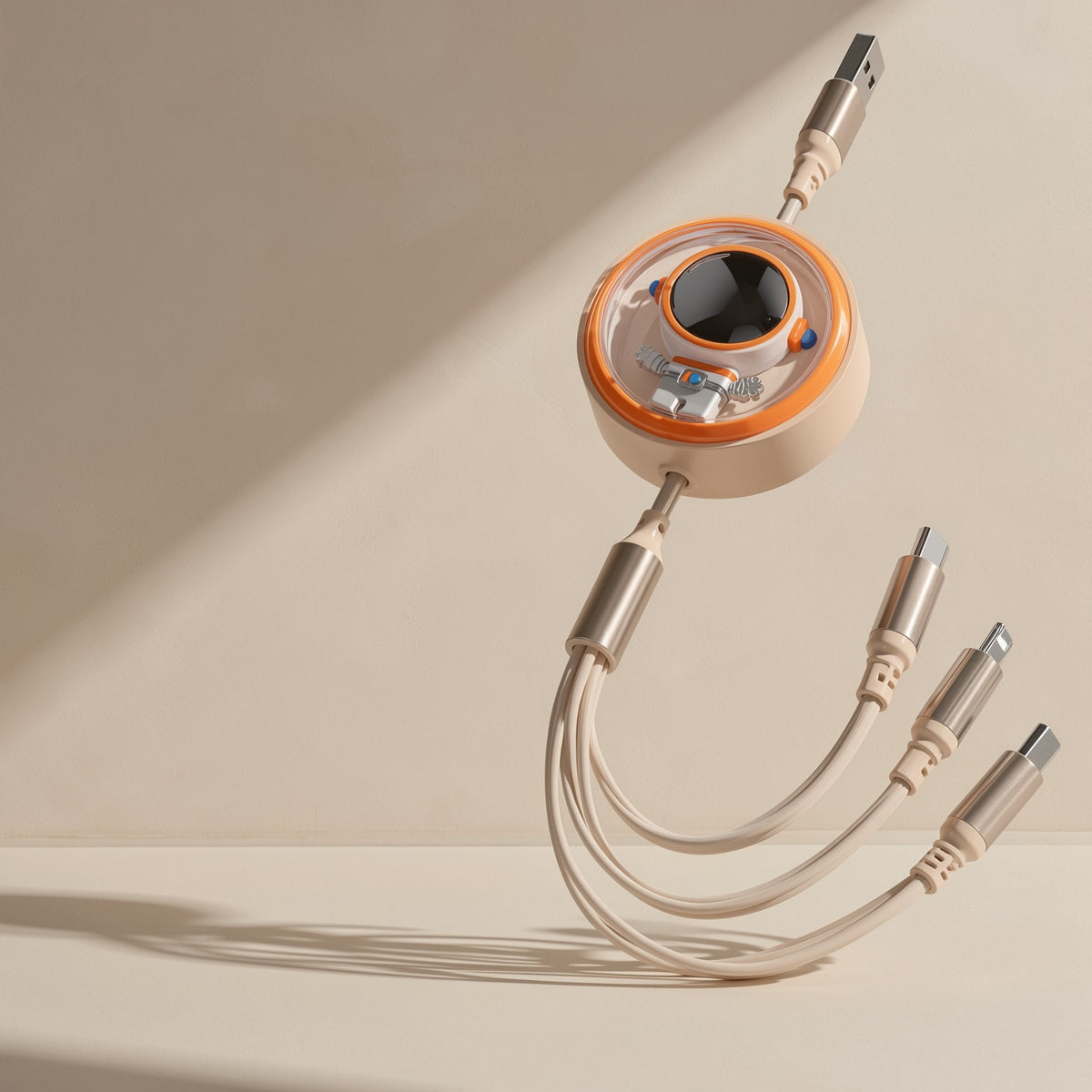 Pullcharge – Cream-colored retractable cable with orange-ringed astronaut window and gold-toned connectors on beige backdrop