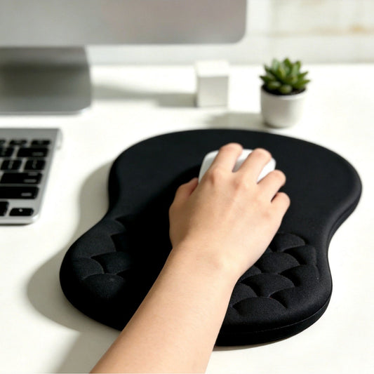 Slopewave – Hand using a white mouse on a black fan-shaped wrist rest pad, with a keyboard and small plant nearby