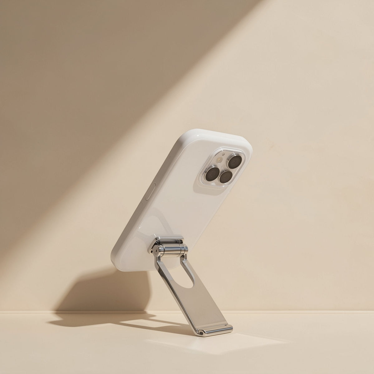 Spinstand Stainless Steel Rotating Tablet Stand propping a white-cased phone upright on a beige surface