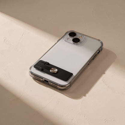Spinstand – Folded black stand with round metal disc attached flat to the back of a clear-cased phone