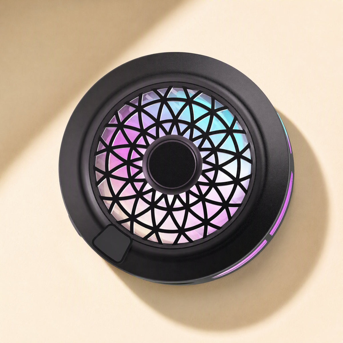 Metalchill Metal Mobile Phone Cooler seen from above, round black body with a rainbow-lit geometric fan grille