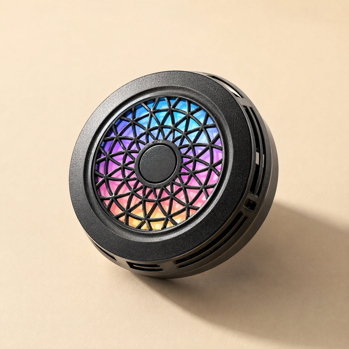 Metalchill – Round black cooler tilted to show side vents and a gradient rainbow grille in pink, blue and orange