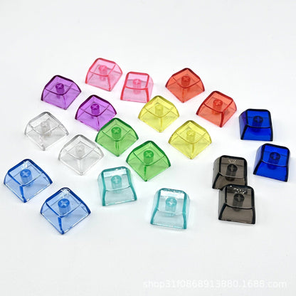 Clarion – Overhead view of assorted translucent keycaps tilted to show the cross-shaped stem sockets on a white background