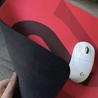 Padhold anti-slip gaming mouse mat in red with a corner peeled back to show the black rubber base and white mouse