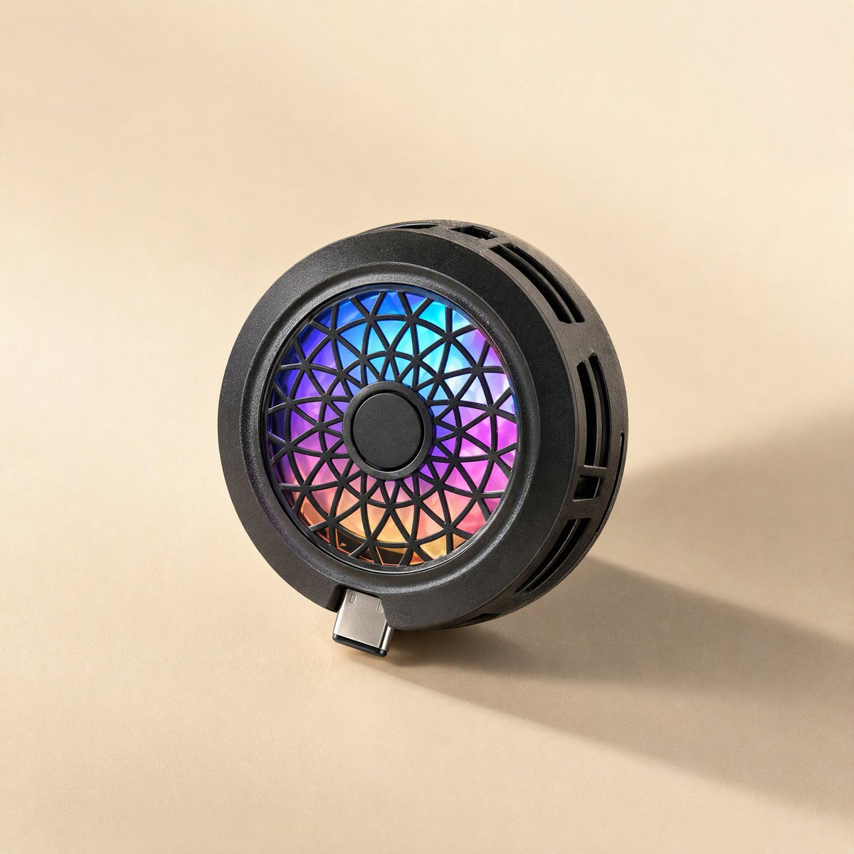 Typechill Mobile Phone Cooler, black round fan with rainbow RGB lights and a Type-C plug on a beige background