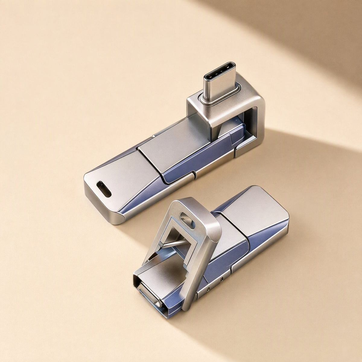 Pivotflash Type-C rotating metal USB flash drive, two units on beige, one with USB-C plug out, one with it folded