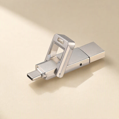 Pivotflash – Silver metal flash drive with swivel frame open and USB-C connector extended, shown on a cream surface