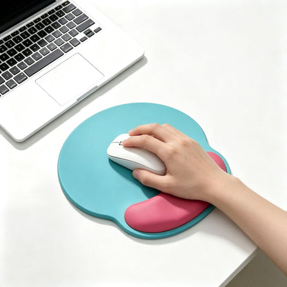 Dualhue – Teal version of the mouse pad with a pink wrist rest, a hand guiding a white mouse next to a laptop
