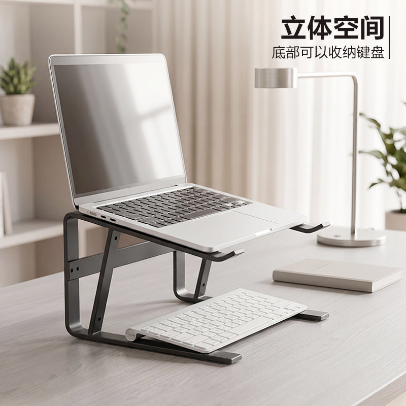 Loftvent – Side view of the stand with a laptop on top and a keyboard tucked in the space underneath, on a light desk
