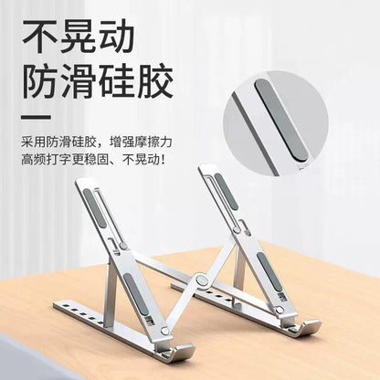 Foldwing Foldable Aluminum Alloy Laptop Stand on a wooden desk with a close-up of its grey anti-slip silicone pad