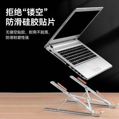 Foldwing – Laptop resting on the stand, with orange arrows marking silicone pads on a wooden desk against a dark background