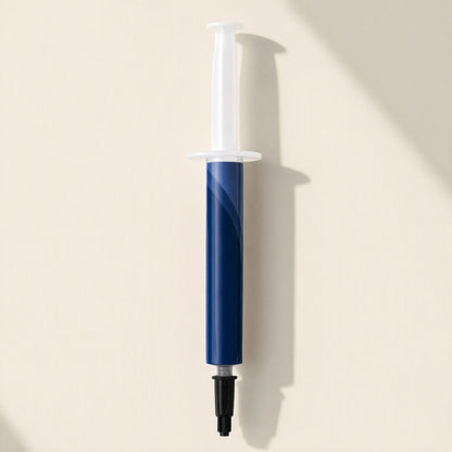 Chipglide – Single blue thermal paste syringe with white plunger and black tip cap, shown upright with shadow