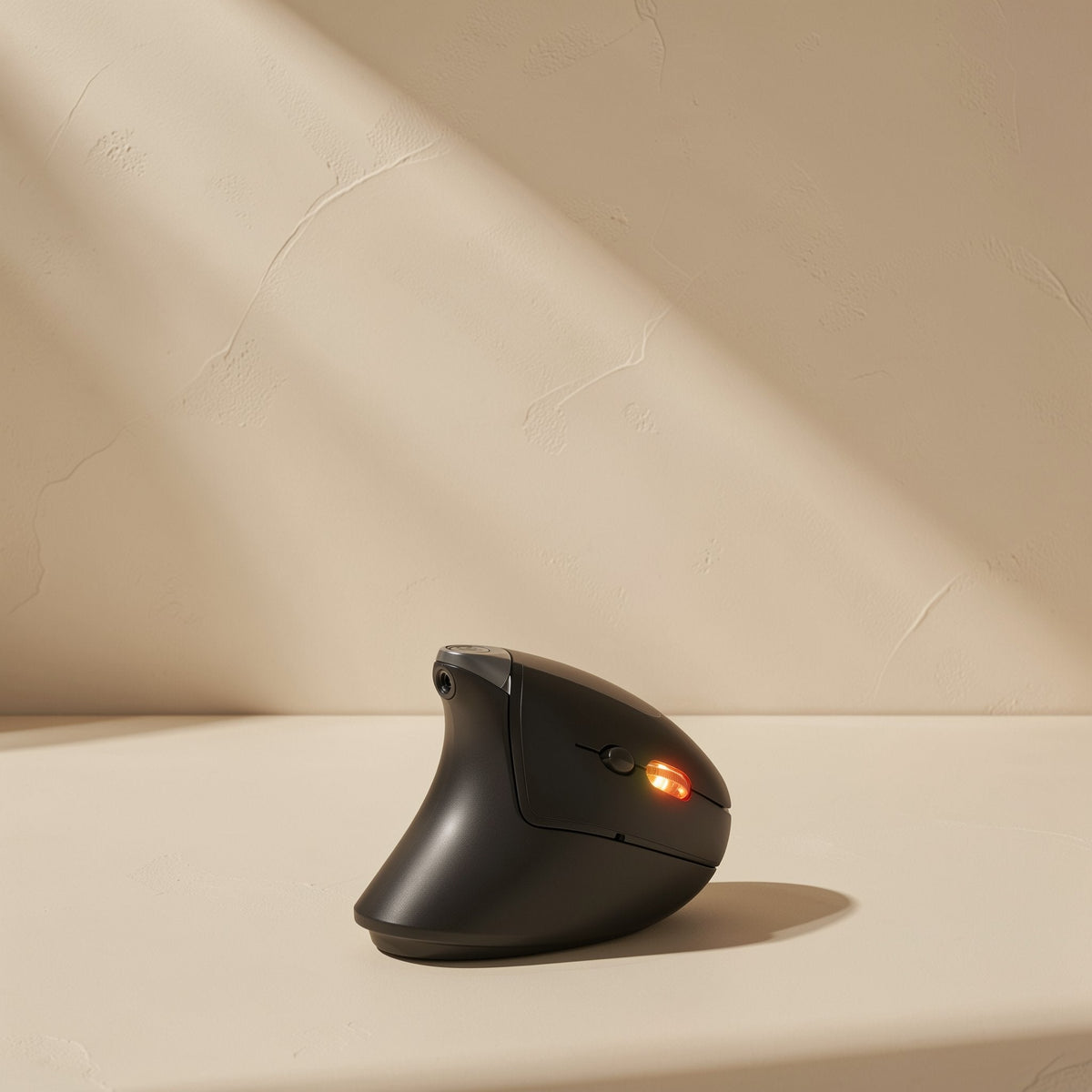 Palmglide – Front view of the black vertical mouse with a glowing orange indicator light and scroll wheel