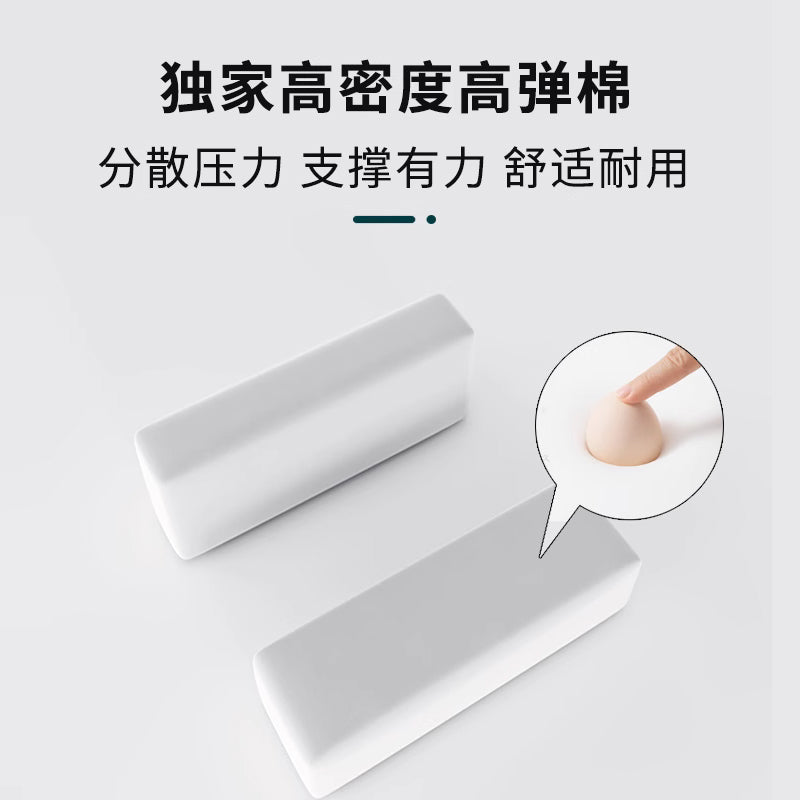 Armrestloom – Two white high-density foam armrest cushion blocks, with a fingertip pressing into the foam in a close-up