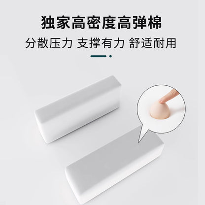 Armrestloom – Two white high-density foam armrest cushion blocks, with a fingertip pressing into the foam in a close-up