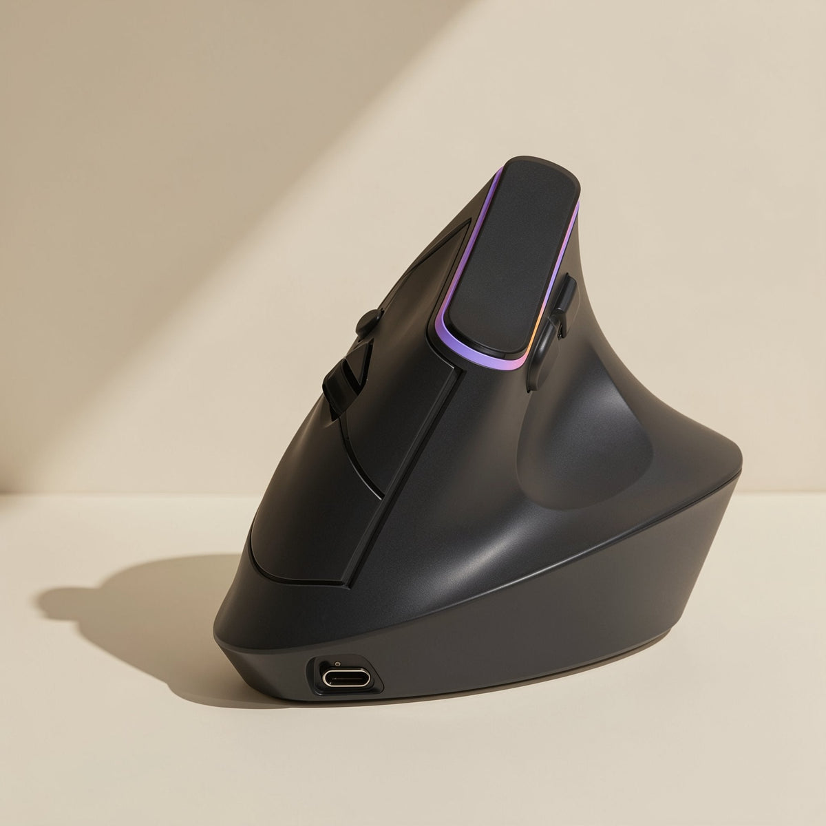 Ergohover – Three-quarter view of the black mouse with a purple-pink light strip and USB-C charging port at the base