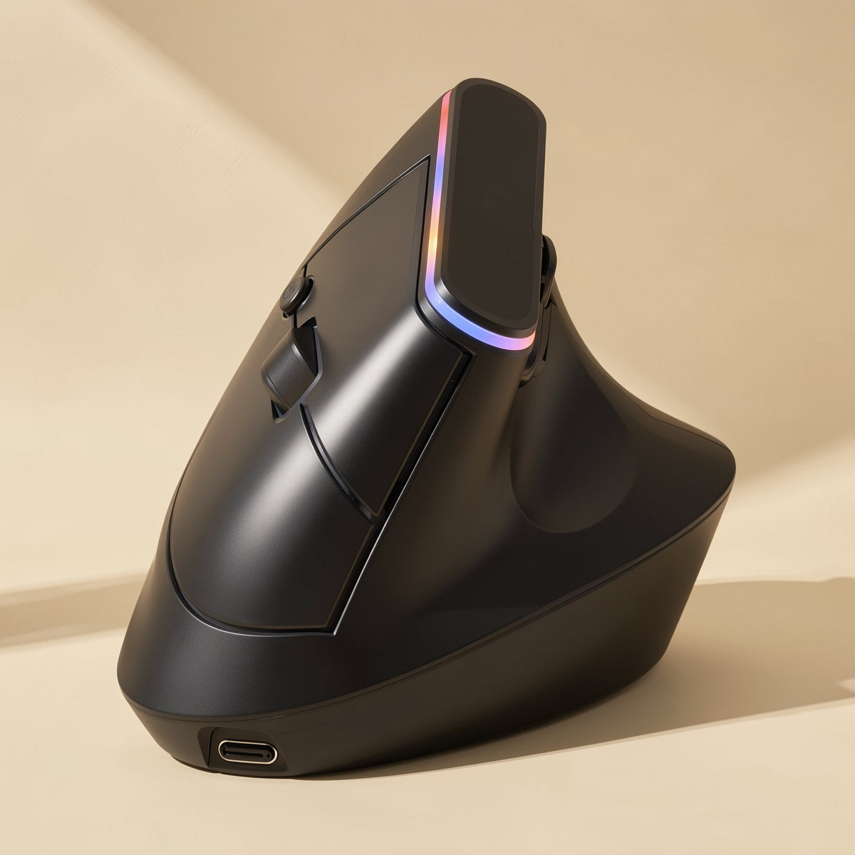 Ergohover – Close-up of the black vertical mouse showing a rainbow light strip, thumb rest and USB-C port on a tan background