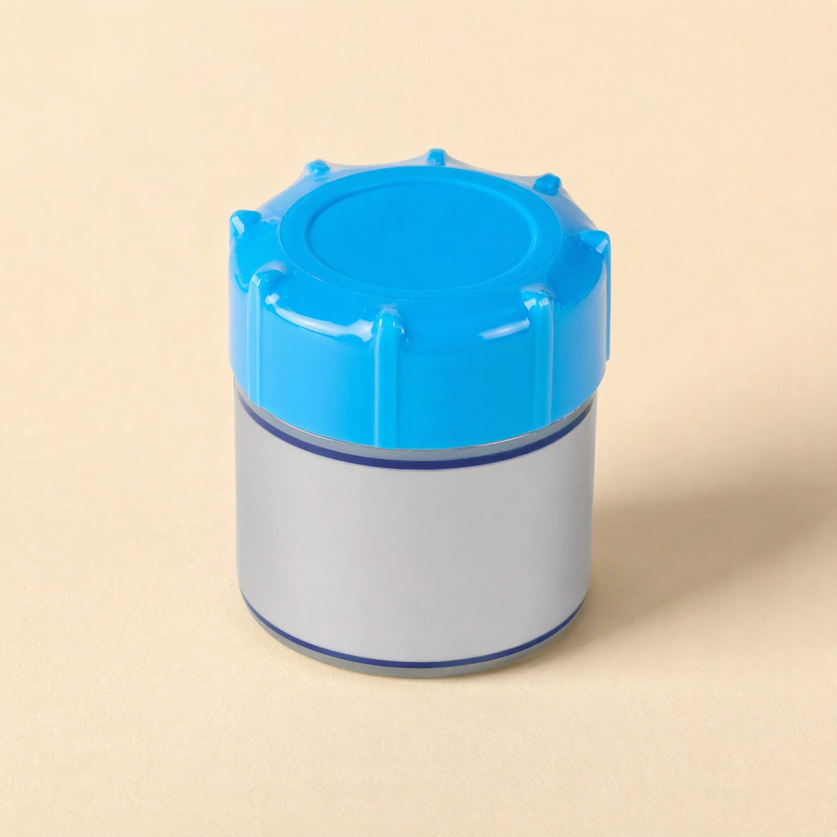 Thermabond 10g CPU thermal paste jar with blue ribbed cap and silver label on a cream background