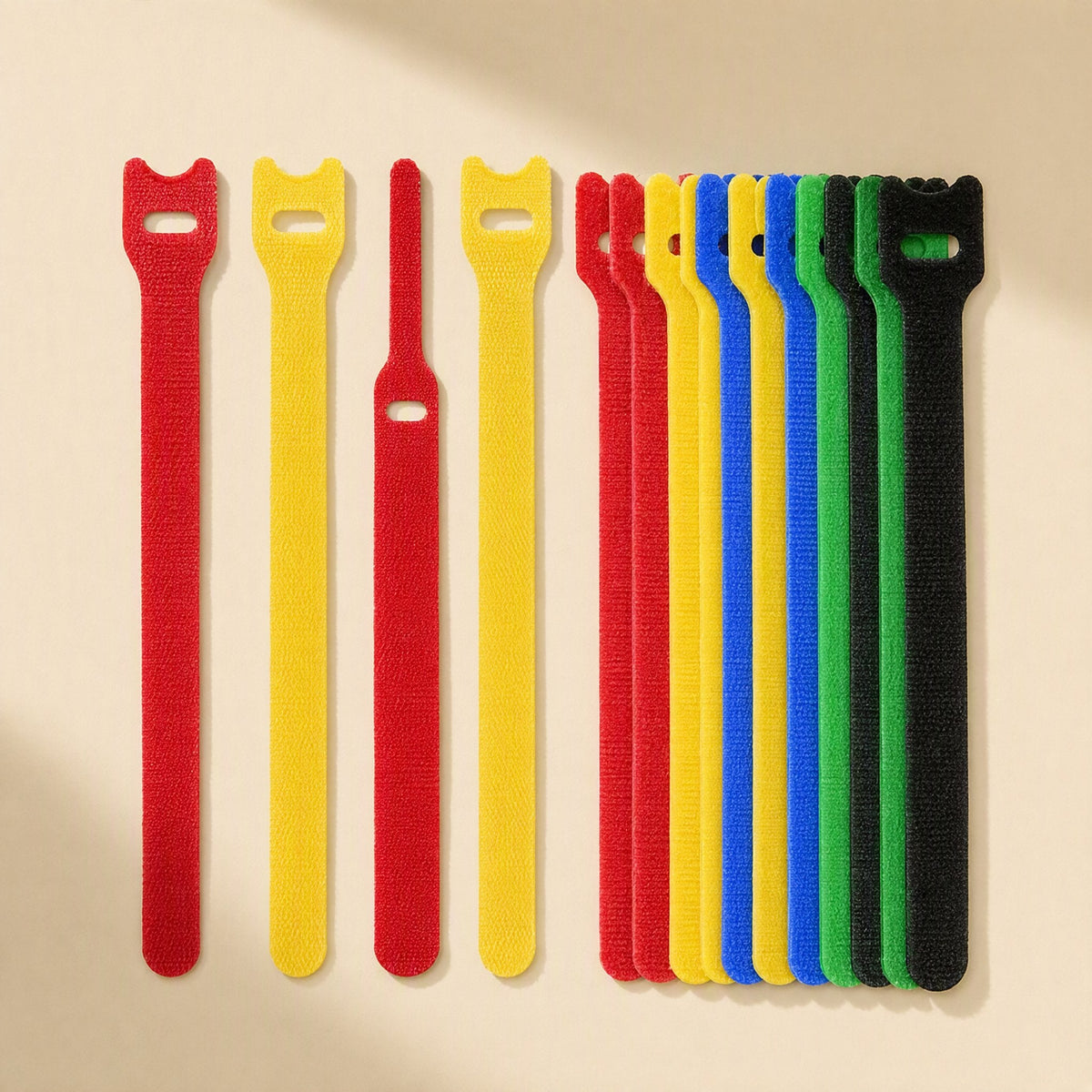 Loopstem T-Shaped Nylon Hook-And-Loop Cable Tie in red, yellow, blue, green and black on a cream background