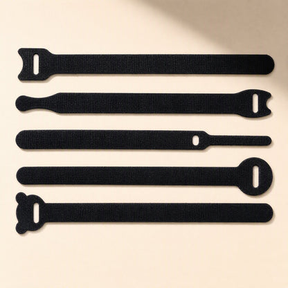 Loopstem – Five black hook-and-loop ties with different end shapes, including rounded and bear-ear tips, laid flat