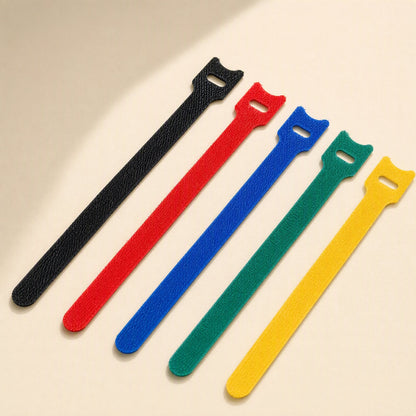 Loopstem – Five T-shaped hook-and-loop ties in black, red, blue, green and yellow fanned out diagonally
