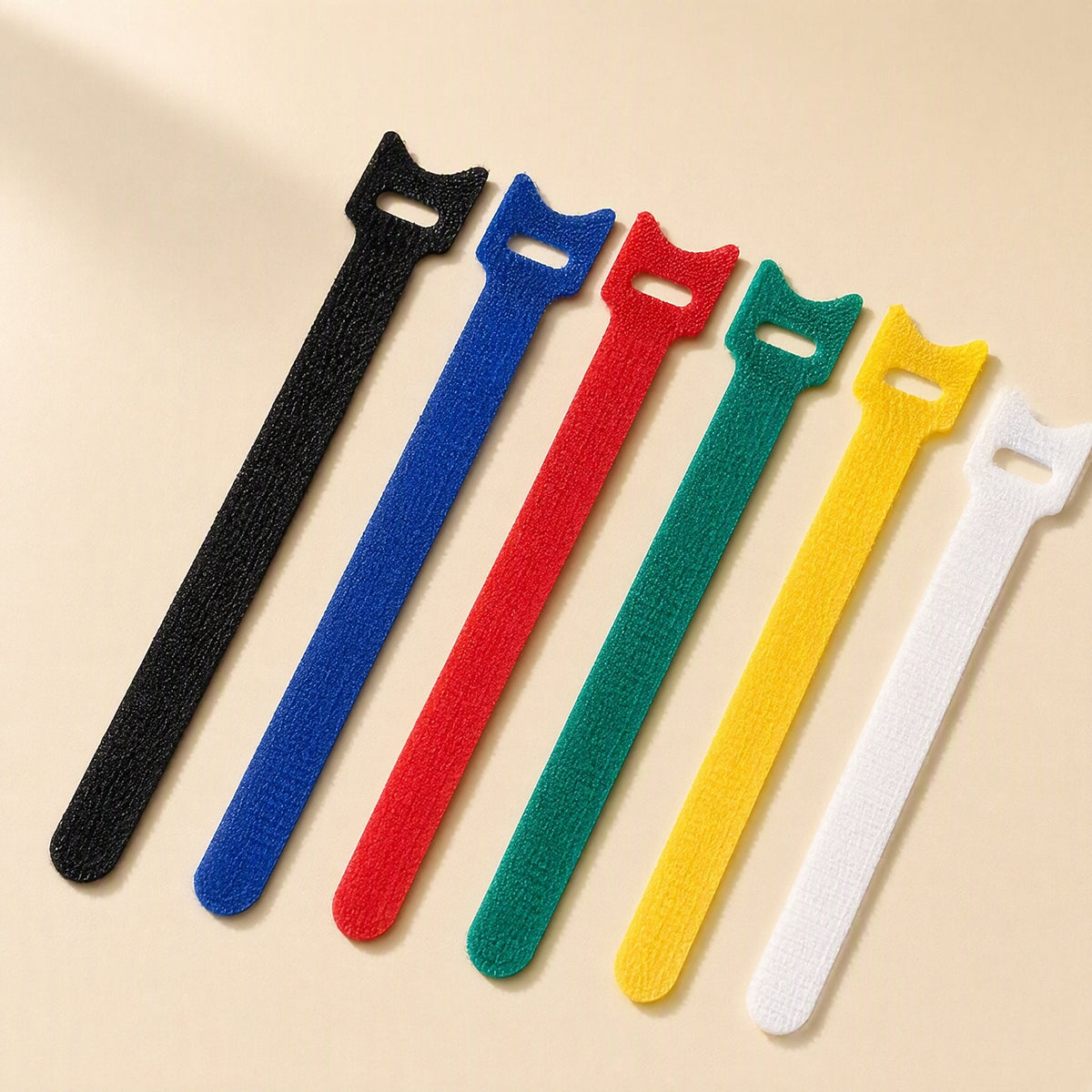 Loopstem – Six hook-and-loop ties in black, blue, red, green, yellow and white arranged at an angle