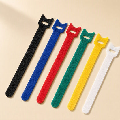 Loopstem – Six hook-and-loop ties in black, blue, red, green, yellow and white arranged at an angle