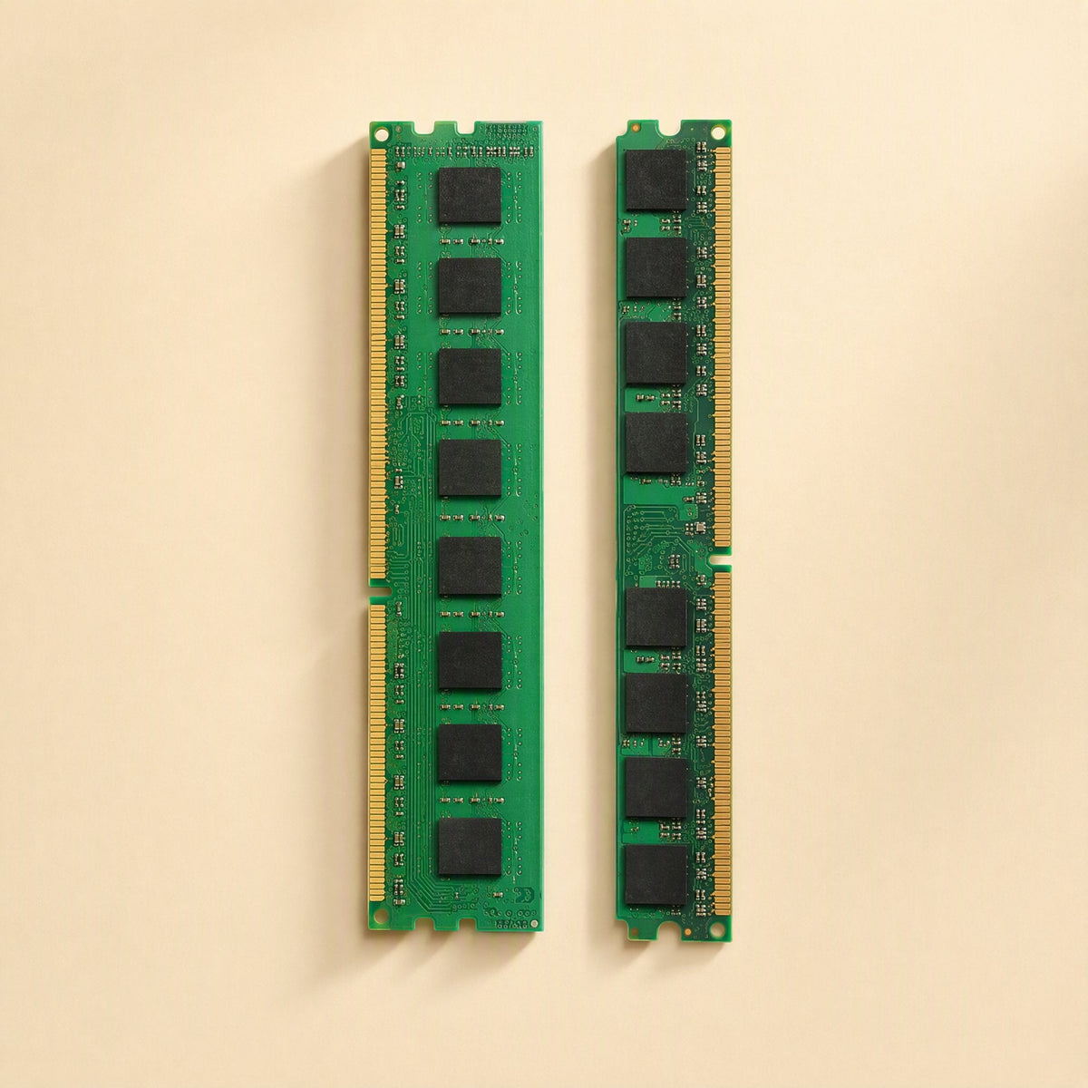 Bitboost – Two green RAM modules standing upright, showing eight black memory chips and gold contacts