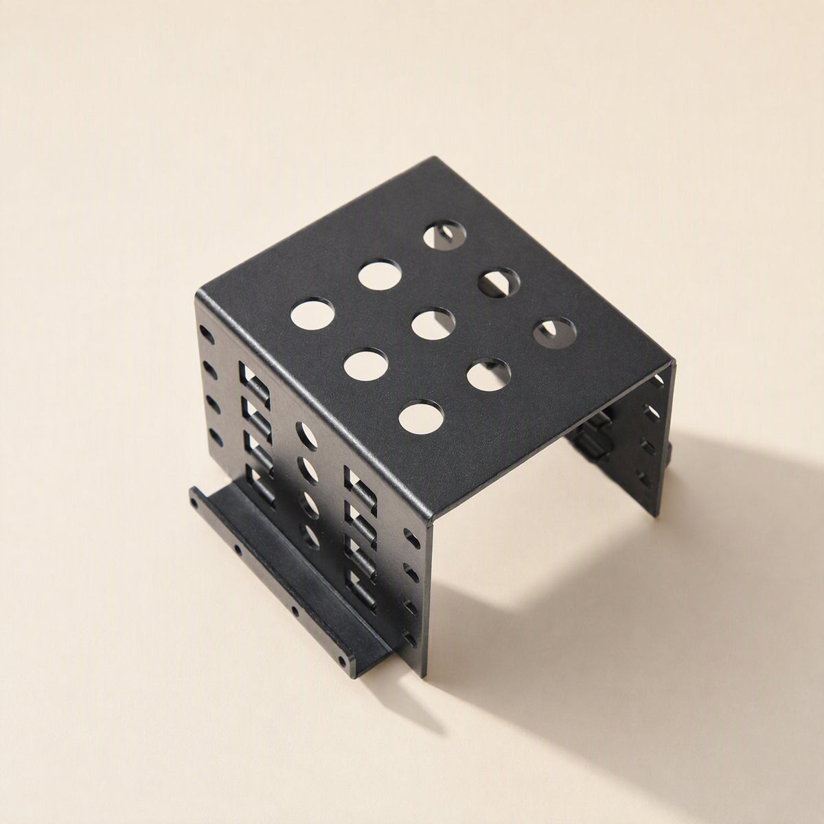 Alloyhold Aluminum Hard Drive Bracket in black, seen from above at an angle with round vent holes on top