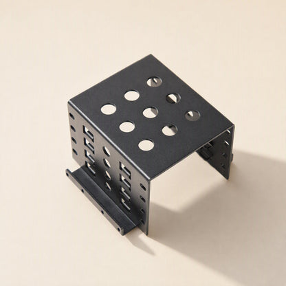 Alloyhold Aluminum Hard Drive Bracket in black, seen from above at an angle with round vent holes on top