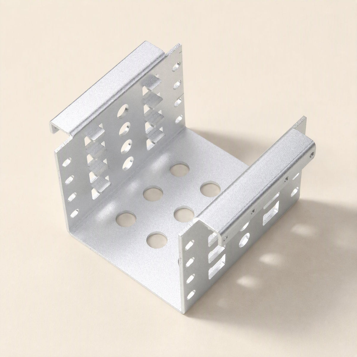 Alloyhold – Silver bracket seen from above and inside, showing the perforated floor and punched side rails