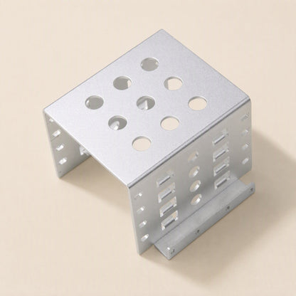 Alloyhold – Silver bracket from the front corner, showing circular top vents and rows of slots on the side