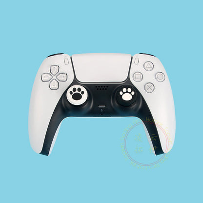 Pawgrip – White PS5 controller with black and white cat paw thumbstick caps on a light blue background