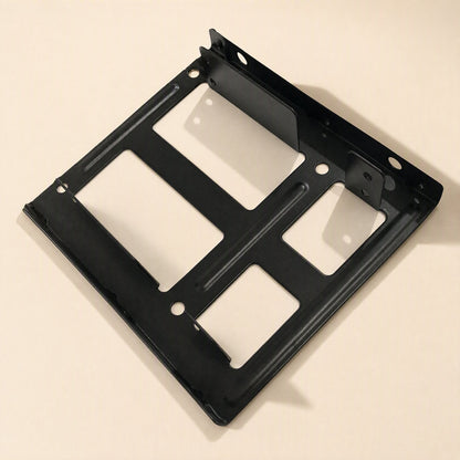 Drivehold – Underside view of the black bracket showing rectangular cutouts and raised stiffening ribs