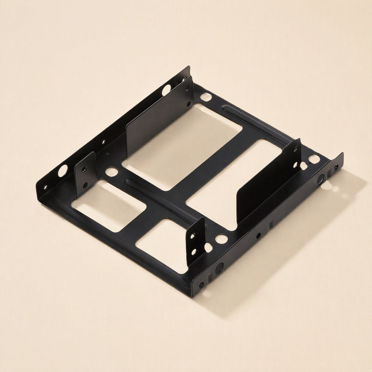 Drivehold – Black metal 2.5 to 3.5 inch bracket seen from a low angle, with two drive slots and side screw holes