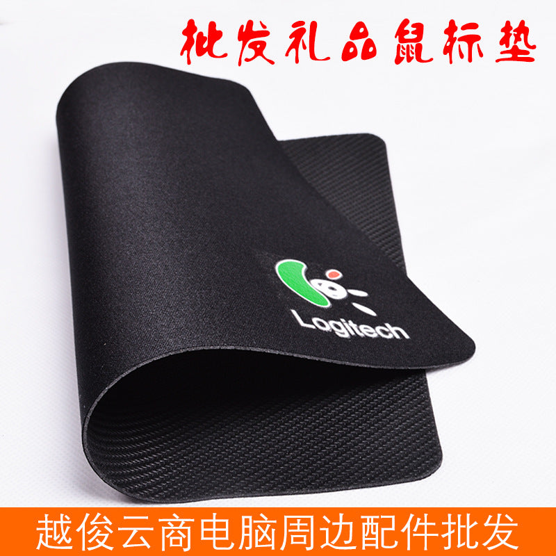 Weavepad – Black mouse pad curled to show the textured rubber underside, with a green Logitech logo on the cloth top