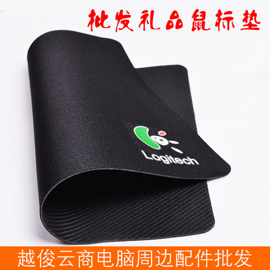 Weavepad – Black mouse pad curled to show the textured rubber underside, with a green Logitech logo on the cloth top
