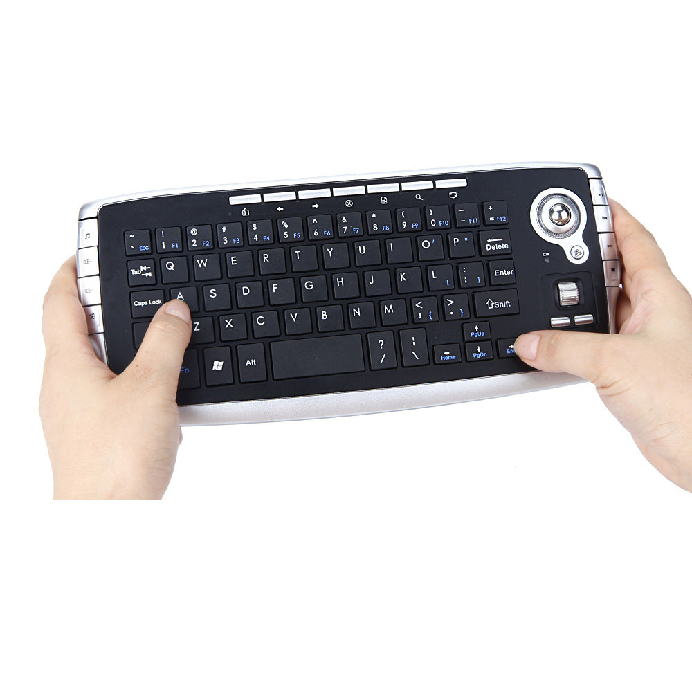 Keytrail Wireless Trackball Keyboard And Mouse Combo held in two hands, thumbs on the keys