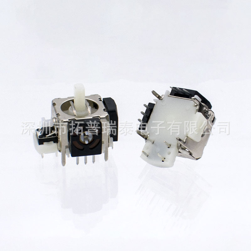 Ohmstick – Black joystick module seen from the front, with a second unit lying on its side showing the white underside